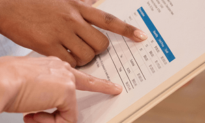 People Pointing at the Numbers on the Invoice