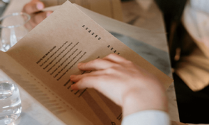 Person holding white menu