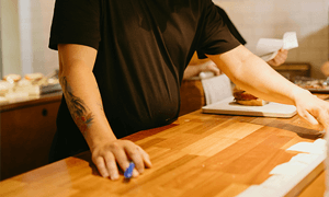 Man in Black T-shirt Standing over Counter in Kitchen